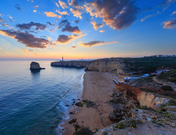 istock Sea coast sunset landscape and lighthouse 1146546921
