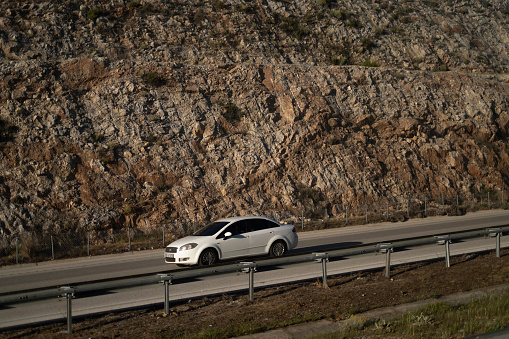 04/30/2019, Izmir-Turkey: A car traveling in the highway which builded inside a mountain road.