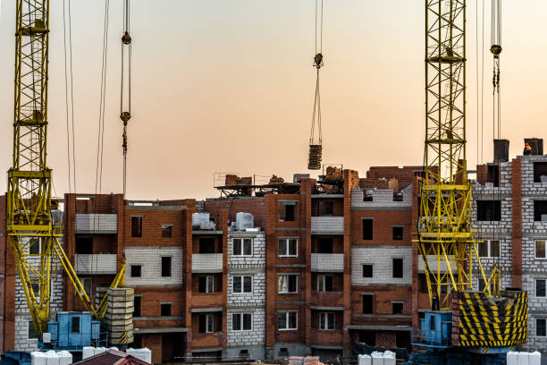 istock Building crane at the background of a multi-storey building under construction 1146547116