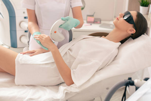 istock Woman in bathrobe undergoing laser hair removal 1146547165