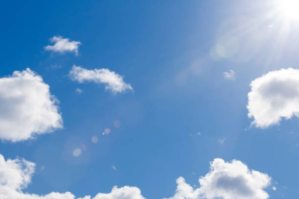 istock Blue skies with fluffy clouds and lens flare 1146551190
