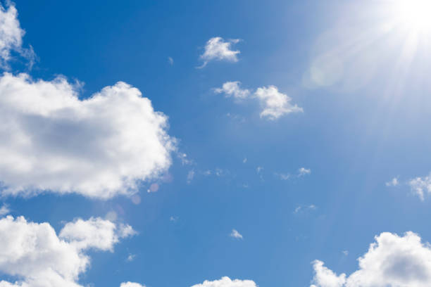 istock Blue skies with fluffy clouds and lens flare 1146551825