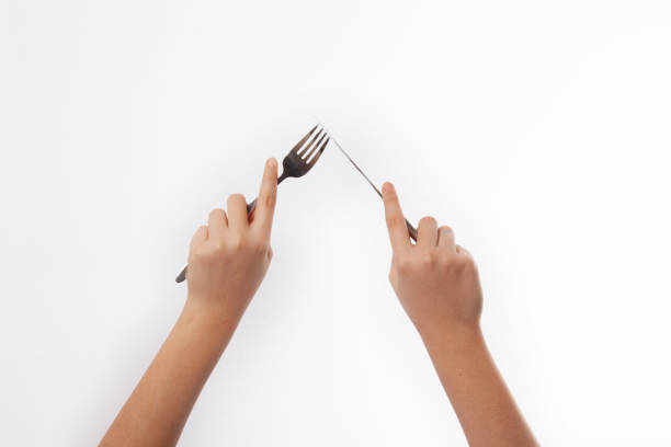 istock Hand and fork knife isolated on white background 1146551891