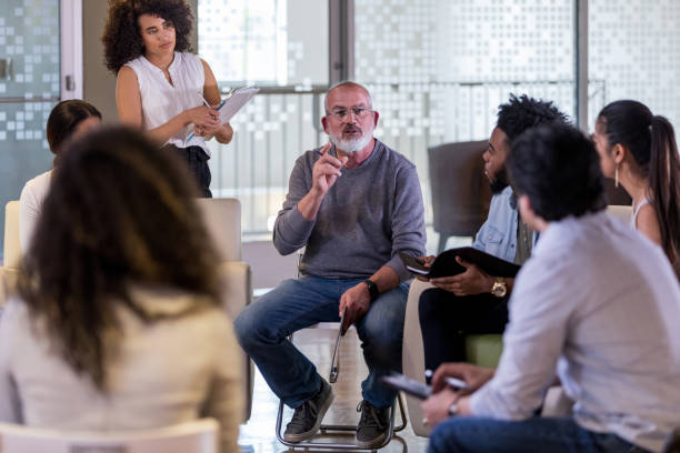 istock Mature man gestures during community meeting 1146552592