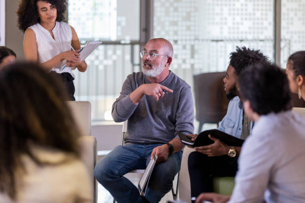 istock Mature man discusses something during community meeting 1146552597