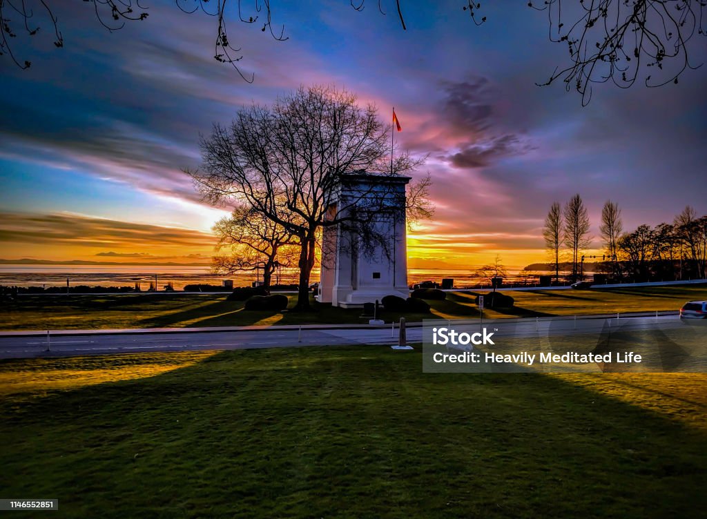 Beautiful Colorful Sunset the Sun Sets Over Trees and the Peace Arch at the Border Crossing Blaine - Washington Stock Photo