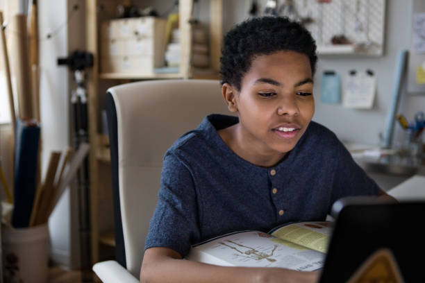 istock Teenage boy concentrates on homework 1146553018