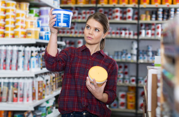 istock Woman is choosing with paint for repair 1146554176