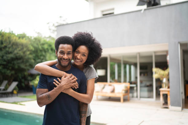 istock Lovely couple smiling outdoors by the pool 1146554290