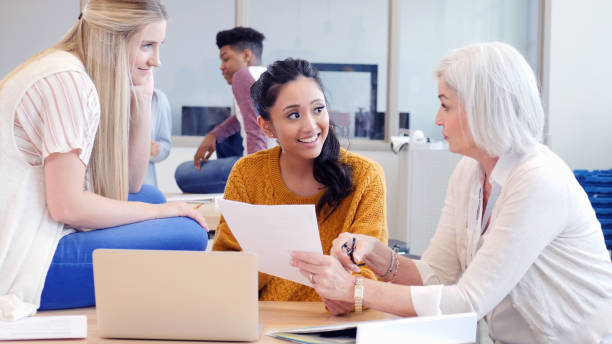 istock Teen girls and teacher plan physics project 1146554326