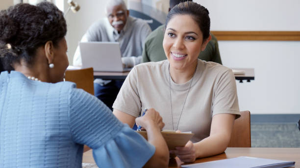 istock Female solder signs loan application at a bank 1146554620