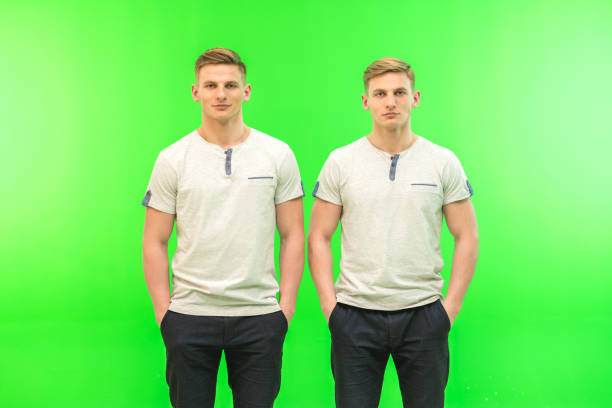 The two handsome twin stand on the green background