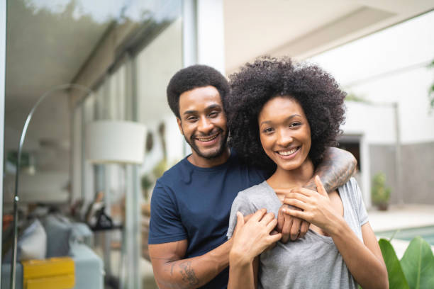 istock Lovely couple smiling outdoors at home 1146555706