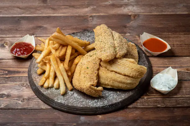 Fried catfish with fries with dipping sauce