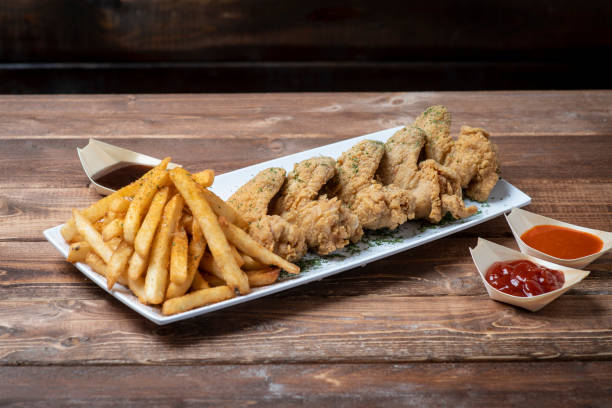 istock Fried chicken wings with fries 1146555943