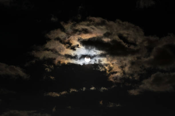 istock Full moon with clouds and colorful corona, also called aureole. 1146556842