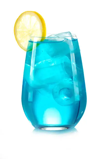 Photo of blue drink with ice cubes and lemon on white background, isolated