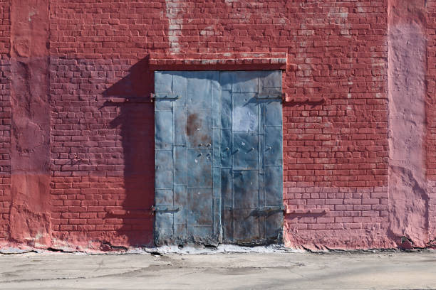 istock Old Blue Painted Industrial Door on Red Brick Wall 1146559177