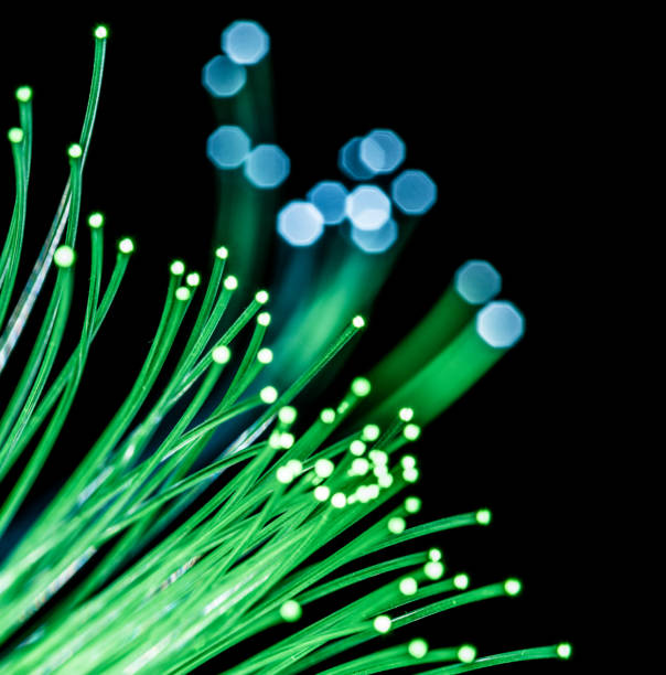 istock Bundle of optical fibers with green light. 1146561385