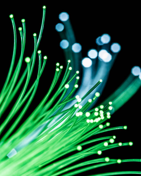 istock Bundle of optical fibers with green light. 1146561962