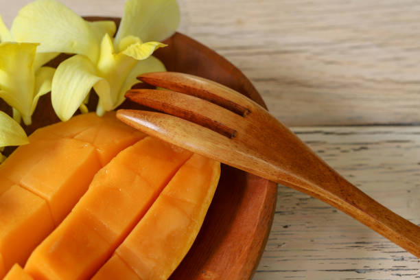 istock cut mango on a wooden background 1146563088