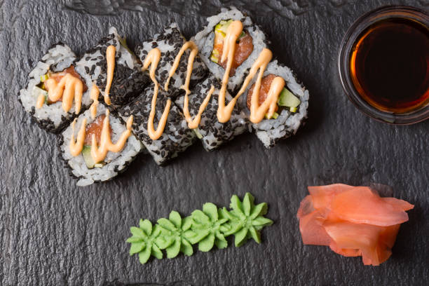 istock Smoked salmon roll sushi served on black stone 1146565002