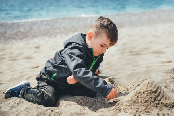 istock Cute happy children, kids having fun on sandy beach, spring vacation 1146566965