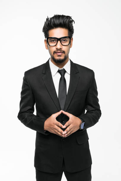 young indian newly recruited employee in formal dress standing with confidence on gray background with smile on face