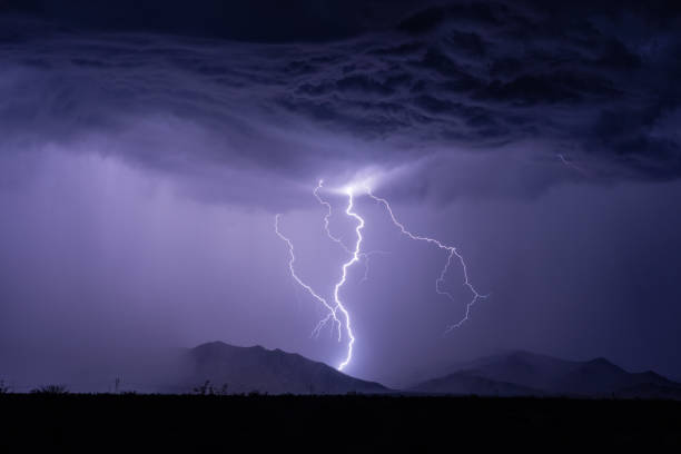 Lightning strikes a mountain stock photo
