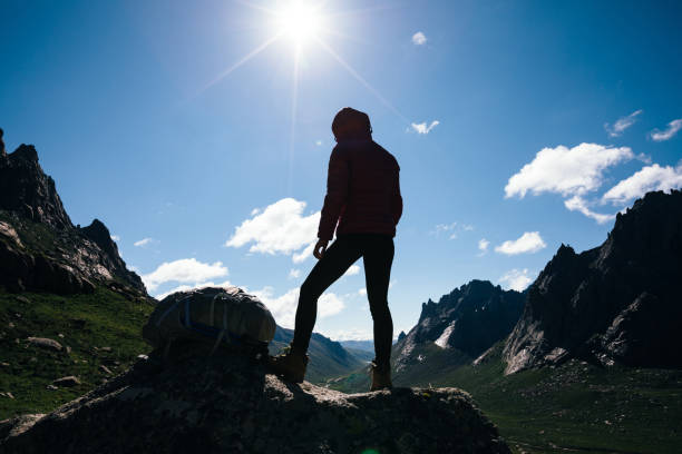 istock Woman hiker with backpack hiking on high altitude mountain top 1146572619