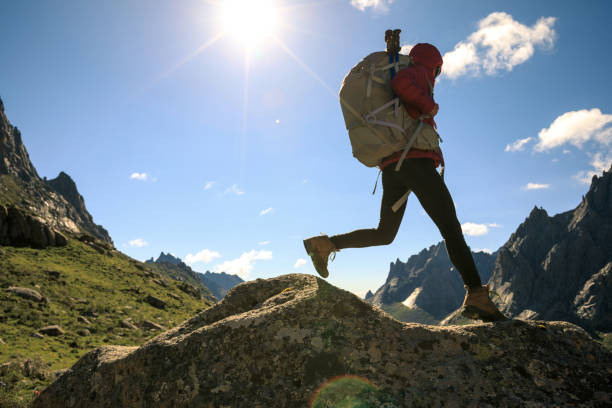 istock Woman hiker with backpack hiking on high altitude mountain top 1146572771