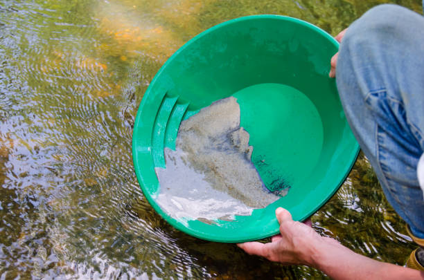 istock Gold panning. Panning for gold in mineral rich stream. 1146574977