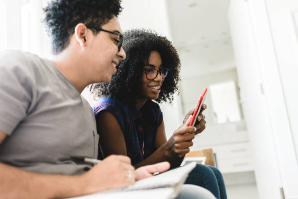 istock Two teenagers studying at home on the couch 1146576619