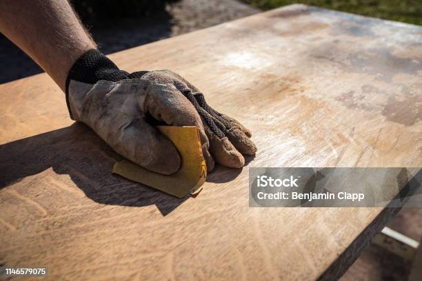 Hand In Glove With Sandpaper Stock Photo - Download Image Now - Sand Paper, Wood - Material, Cabinet