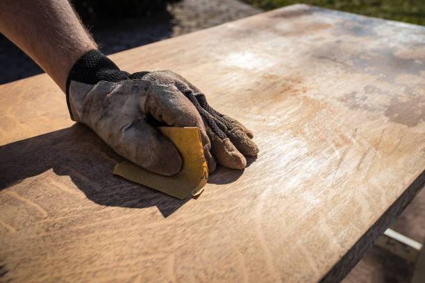 hand in glove with sandpaper - carpenter restoring furniture wood imagens e fotografias de stock