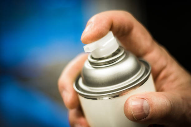 aerosol spray can in hand ready to dispense. - insect repellant imagens e fotografias de stock