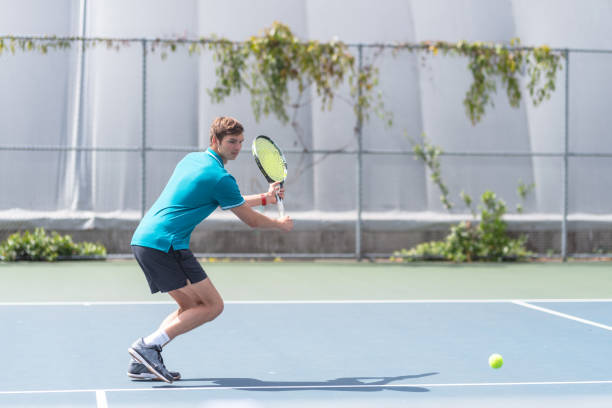 istock A young male tennis player returning a serve 1146579178