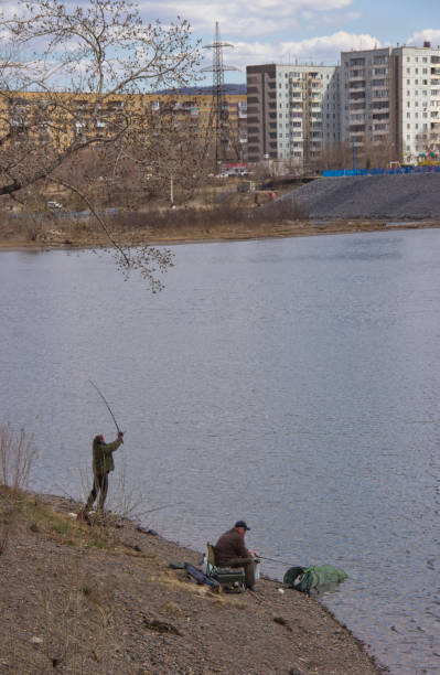 istock fishermen on the river in the city 1146588589