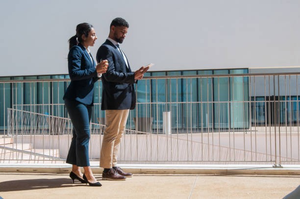 istock Business people using tablet and standing outdoors 1146589497