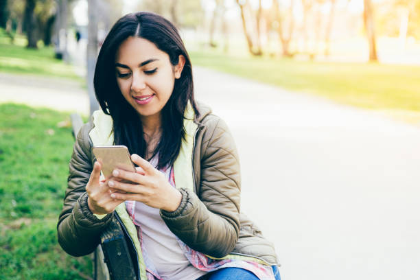 istock Smiling content woman reading message on smartphone 1146589852