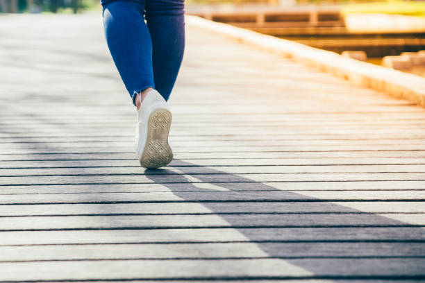 istock Girl walking down path in city park 1146589940