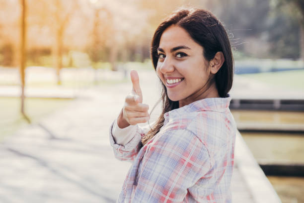 istock Cheerful girl making gun shot gesture 1146590006