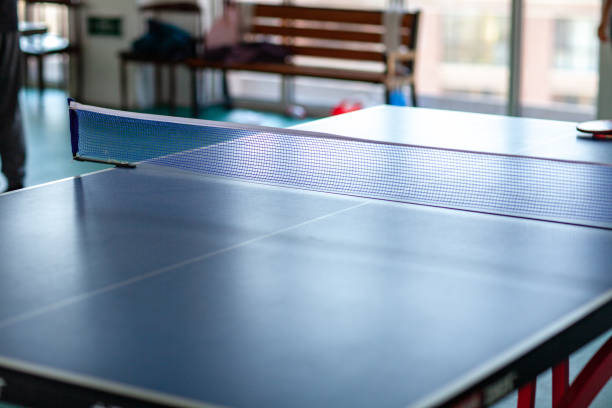 istock pingpong rackets and ball and net on a blue pingpong table 1146591066