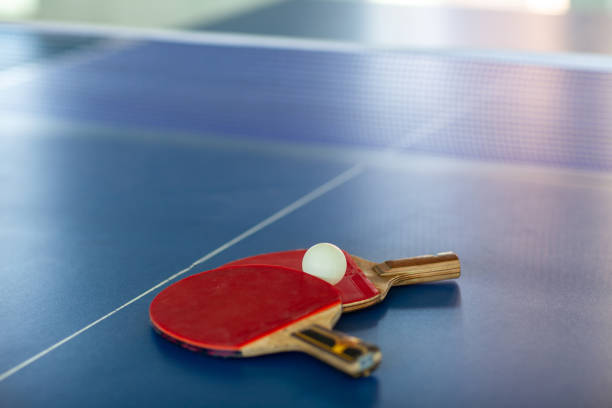 istock pingpong rackets and ball and net on a blue pingpong table 1146591092