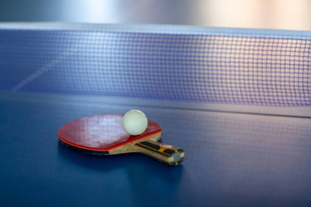 istock pingpong rackets and ball and net on a blue pingpong table 1146591129