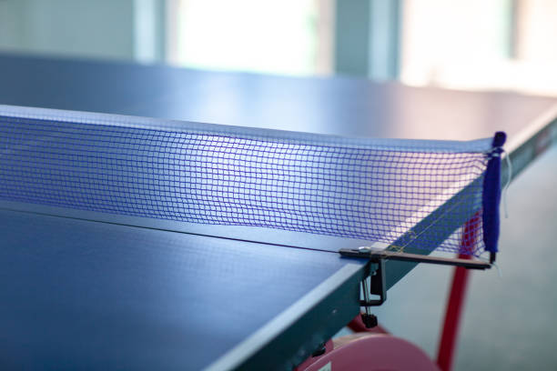 istock pingpong rackets and ball and net on a blue pingpong table 1146591138
