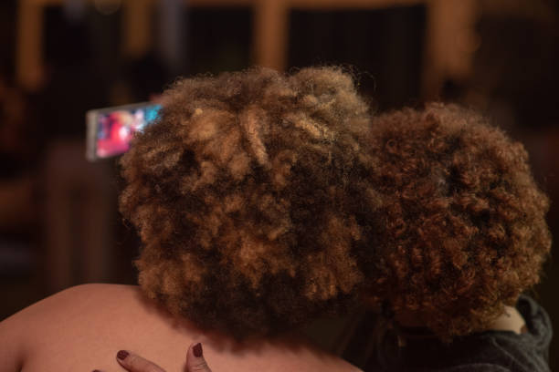 istock Two ladies with afro hair shot from behind while taking a selfie 1146591139