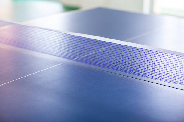 istock pingpong rackets and ball and net on a blue pingpong table 1146591142
