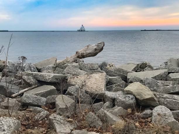 istock Sunrise Over Lake Michigan With Lighthouse 1146599435