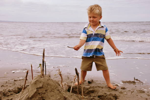 istock Child with Sandcastle at the Beach 1146599698